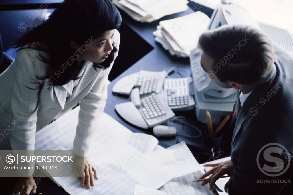 Businessman and a businesswoman talking in an office