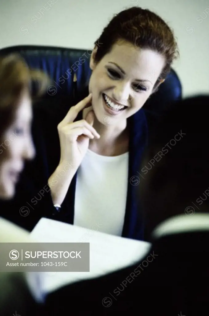 Two businesswomen and a businessman in a meeting