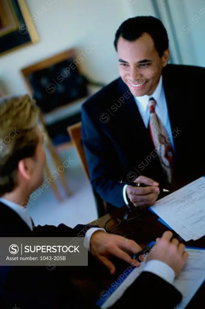 Two businessmen talking in a meeting
