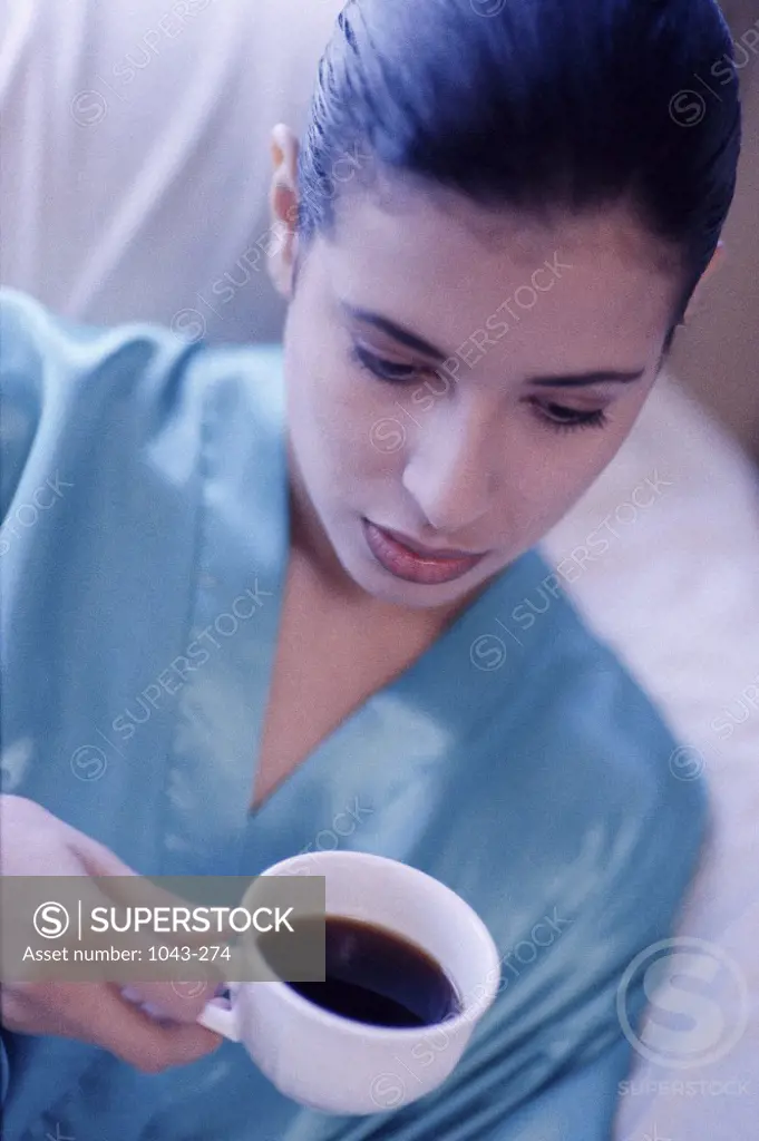 Young woman holding a cup of coffee