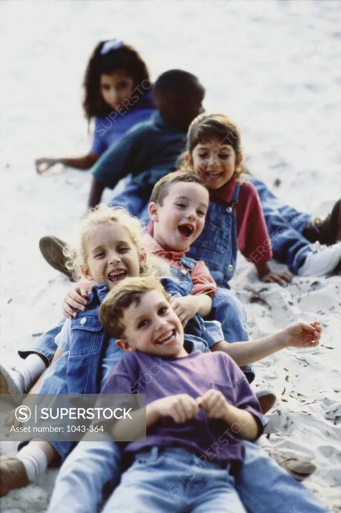 Group of children lying on the sand