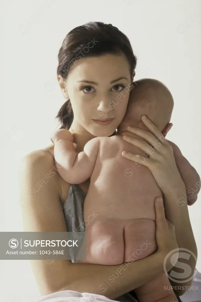 Portrait of a mother hugging her baby boy