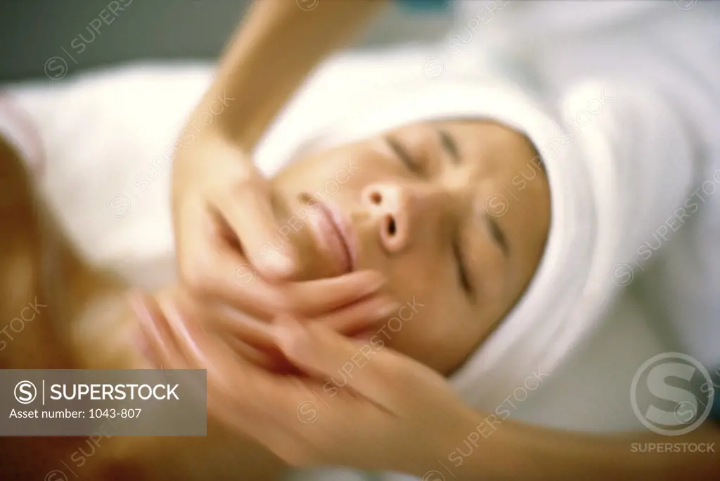 Young woman getting a facial massage