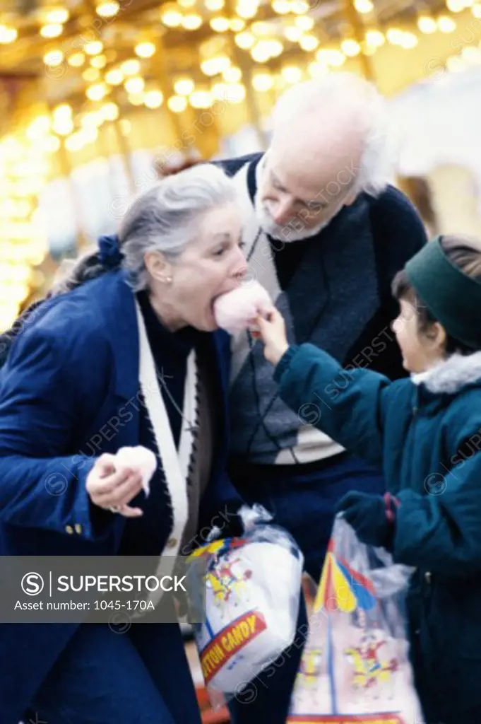 Granddaughter feeding her grandparents