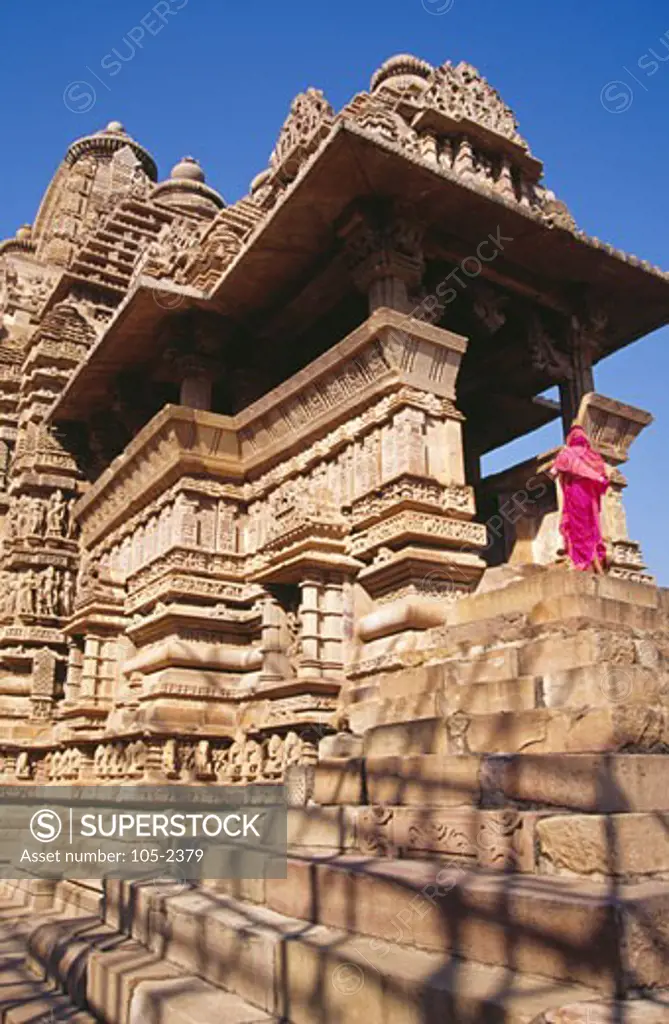 India, Madhya Pradesh, Khajuraho, Rear view of woman walking at Lakshmana Temple