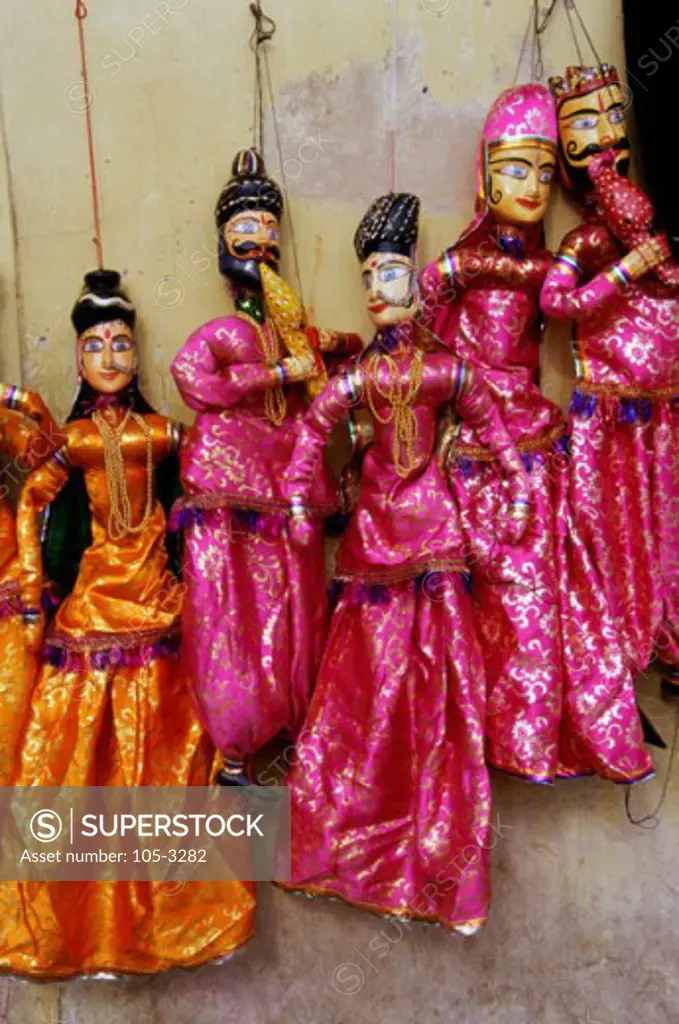 Close-up of puppets hanging on a wall, India