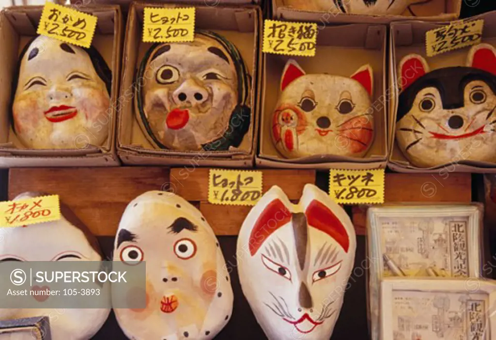 Close-up of papier mache masks in a market stall, Japan