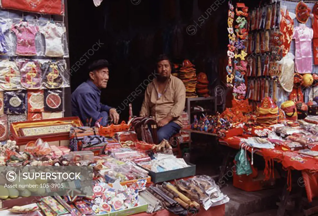 Two market vendors sitting in a store, Pingyao, Shanxi Province, China
