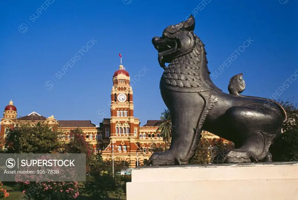 Lion's statue with supreme court in the background, Yangon, Myanmar