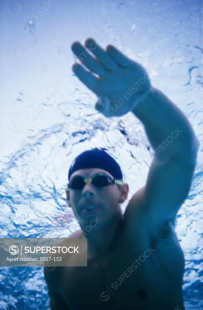 Close-up of a young man swimming underwater