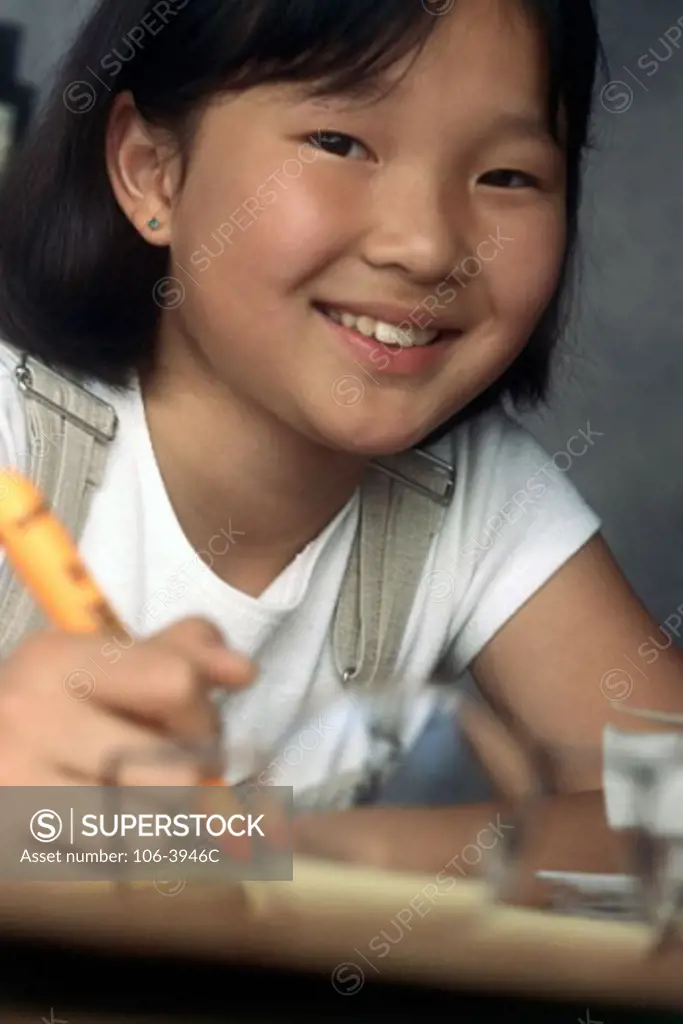 Portrait of a girl holding a crayon