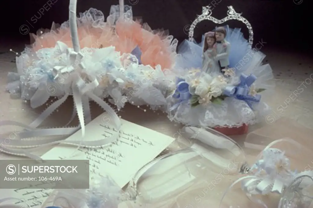 Close-up of wedding decorations with champagne flutes and wedding invitations