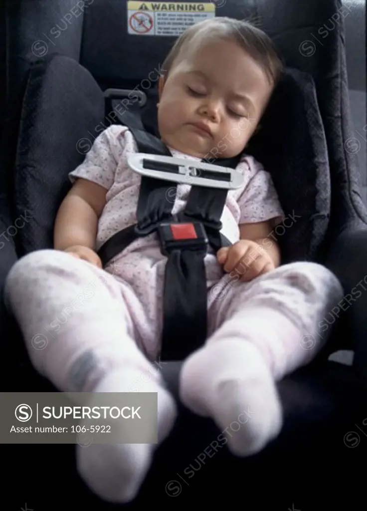 Close-up of a baby boy sleeping in a car