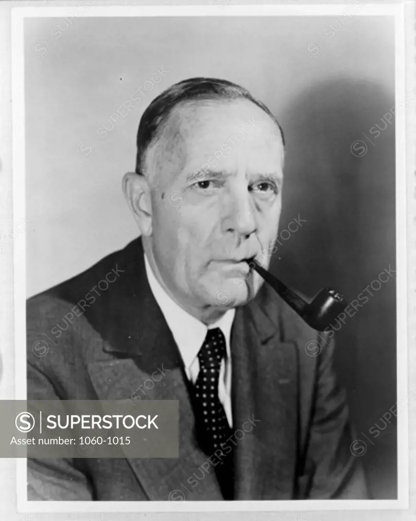 PORTRAIT OF EDWIN HUBBLE SMOKING HIS PIPE.