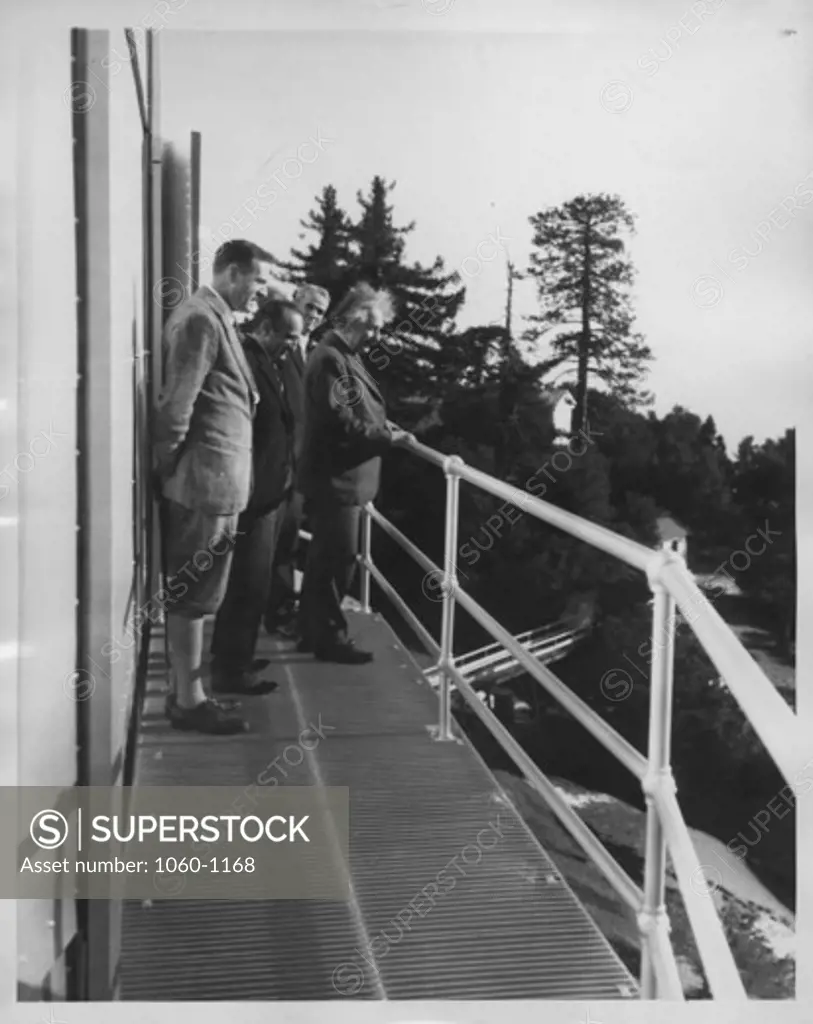 (L to R): Edwin P. Hubble, Walther Mayer, Walter S. Adams, & Albert Einstein on the exterior catwalk of the 100"" telescope dome on Mt. Wilson