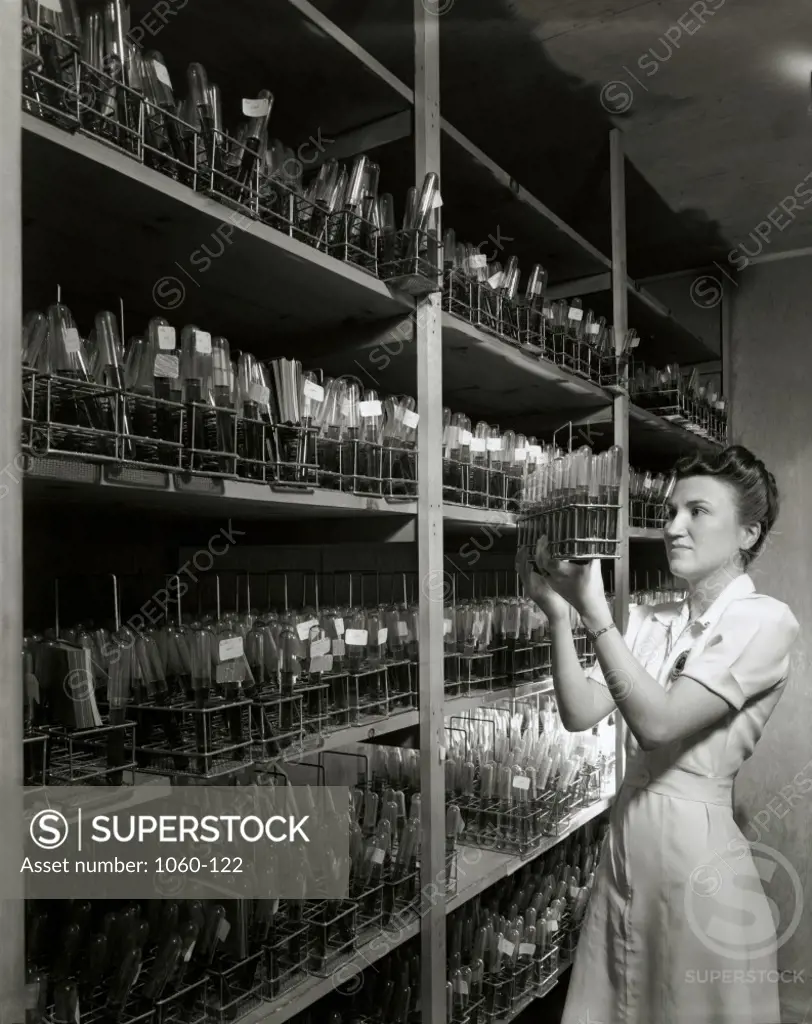 Side profile of a female nurse holding blood samples in a laboratory