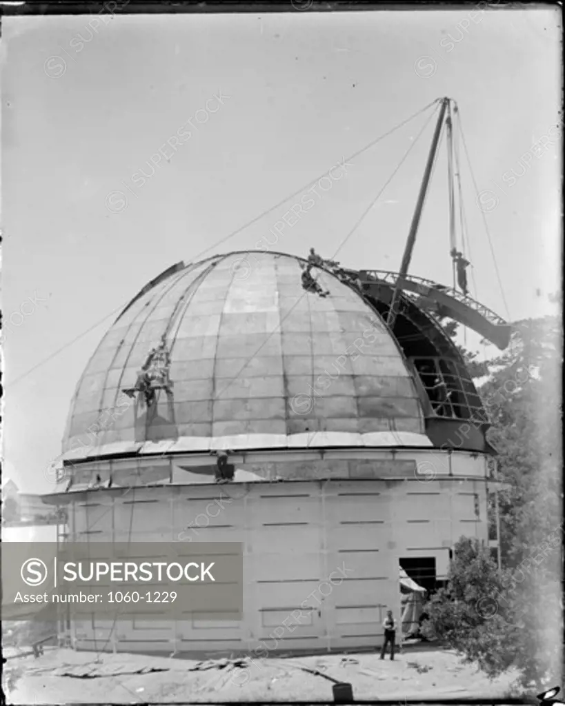 60-INCH TELESCOPE DOME UNDER CONSTRUCTION; PORTION OF SHUTTER FRAME BEING HOISTED INTO PLACE.