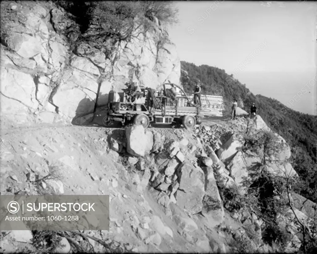COUPLED-GEAR TRUCK & HORSE TEAMS ON BEND OF MT. WILSON TOLL ROAD ABOVE MARTIN'S CAMP WATER TUNNEL; THEY ARE CARRYING SECTIONS OF THE 60-FOOT TOWER TELESCOPE.  DOWD & WILLIS RITCHEY ARE PICTURED.