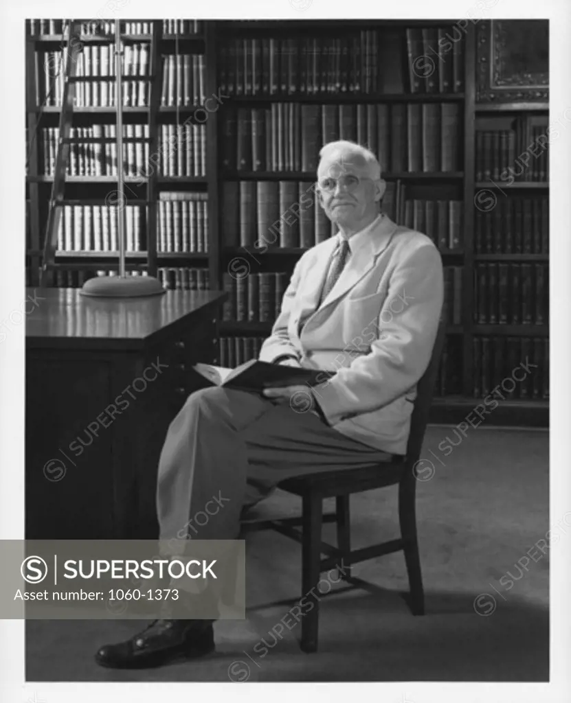 ROSCOE SANFORD SEATED IN THE HALE LIBRARY.