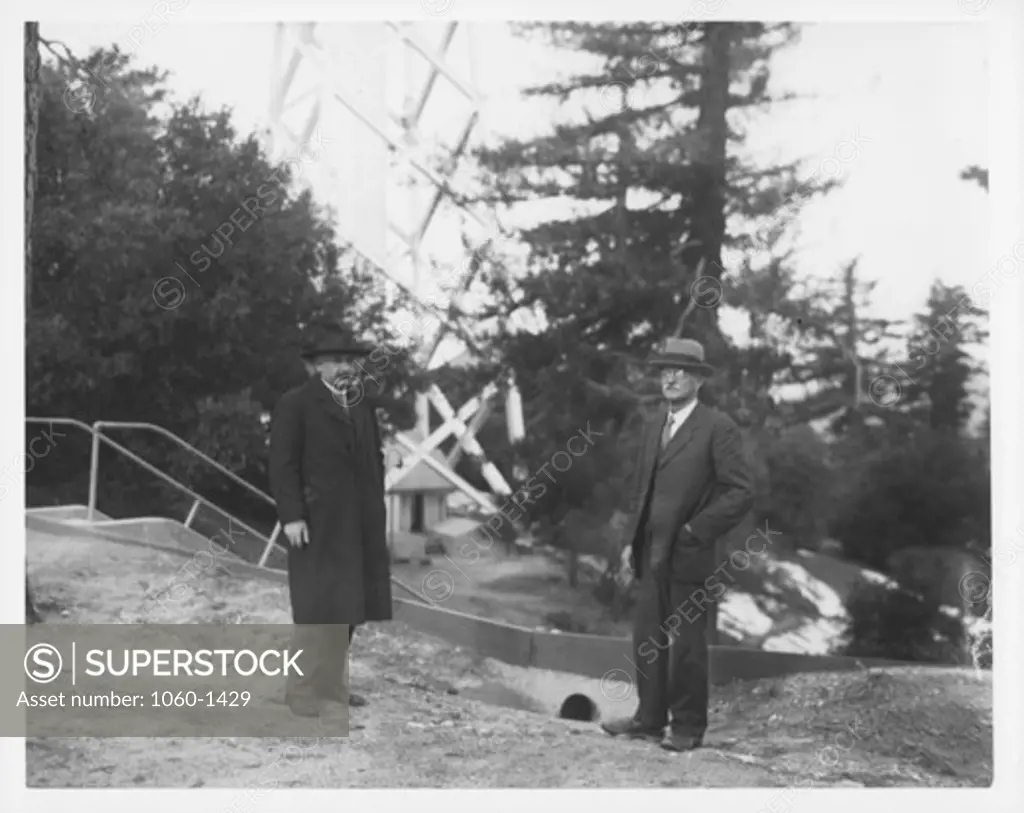 ALBERT EINSTEIN & CHARLES ST. JOHN STANDING ON MT. WILSON NEAR THE 150-FOOT TOWER TELESCOPE.