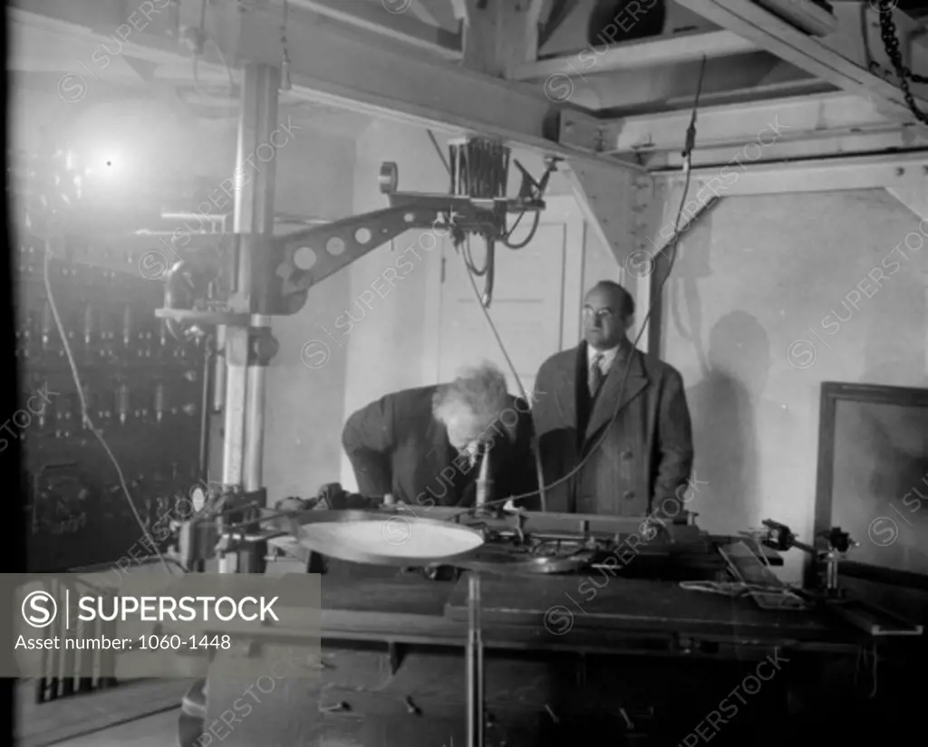 (L TO R): ALBERT EINSTEIN & WALTHER MAYER AT THE FOCUS OF THE 150-FOOT TOWER TELESCOPE.