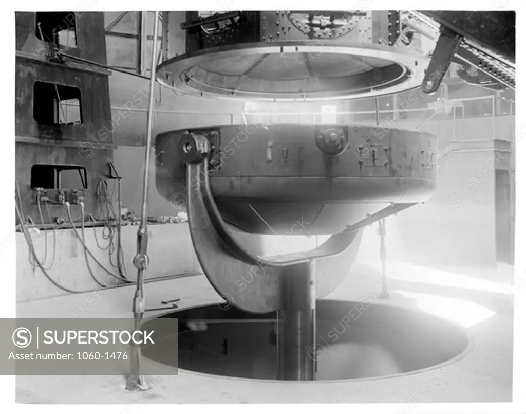 100-INCH MIRROR IN ITS CELL APPROACHING THE LOWER END OF THE TUBE WHERE IT WILL BE BOLTED TIGHTLY.