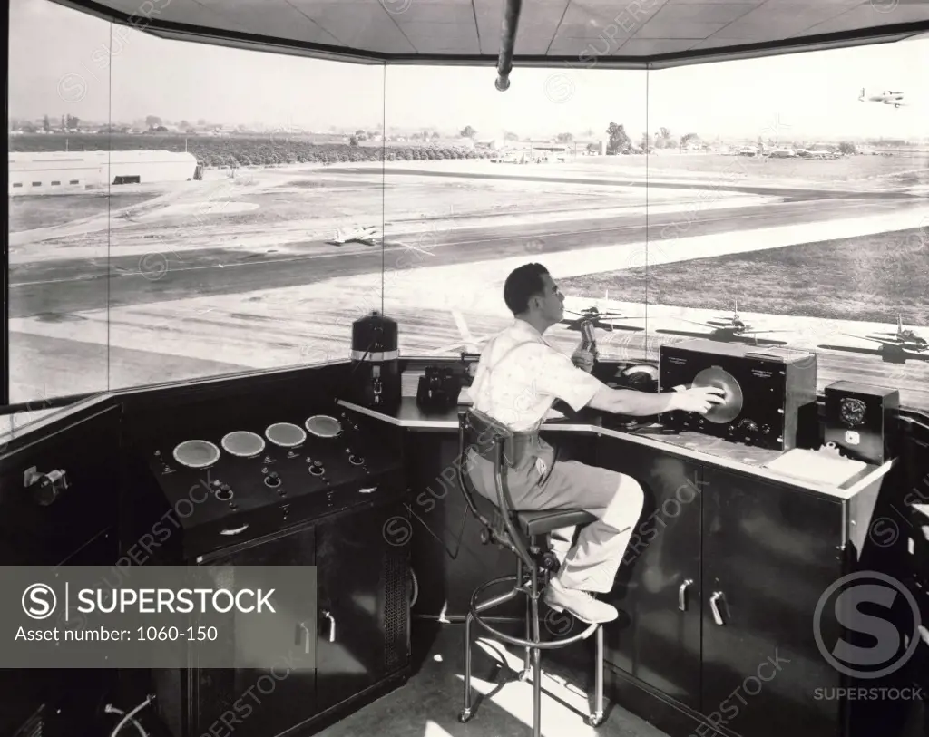 Side profile of an air traffic controller sitting in an air traffic control tower, 1941