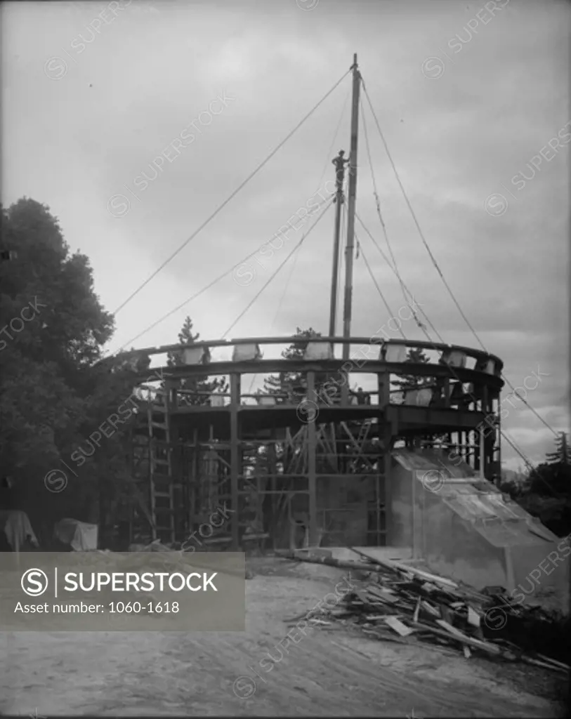 CONSTRUCTION OF 60-INCH TELESCOPE BUILDING.  GEORGE JONES STANDING ON TOP OF JIN POLE.