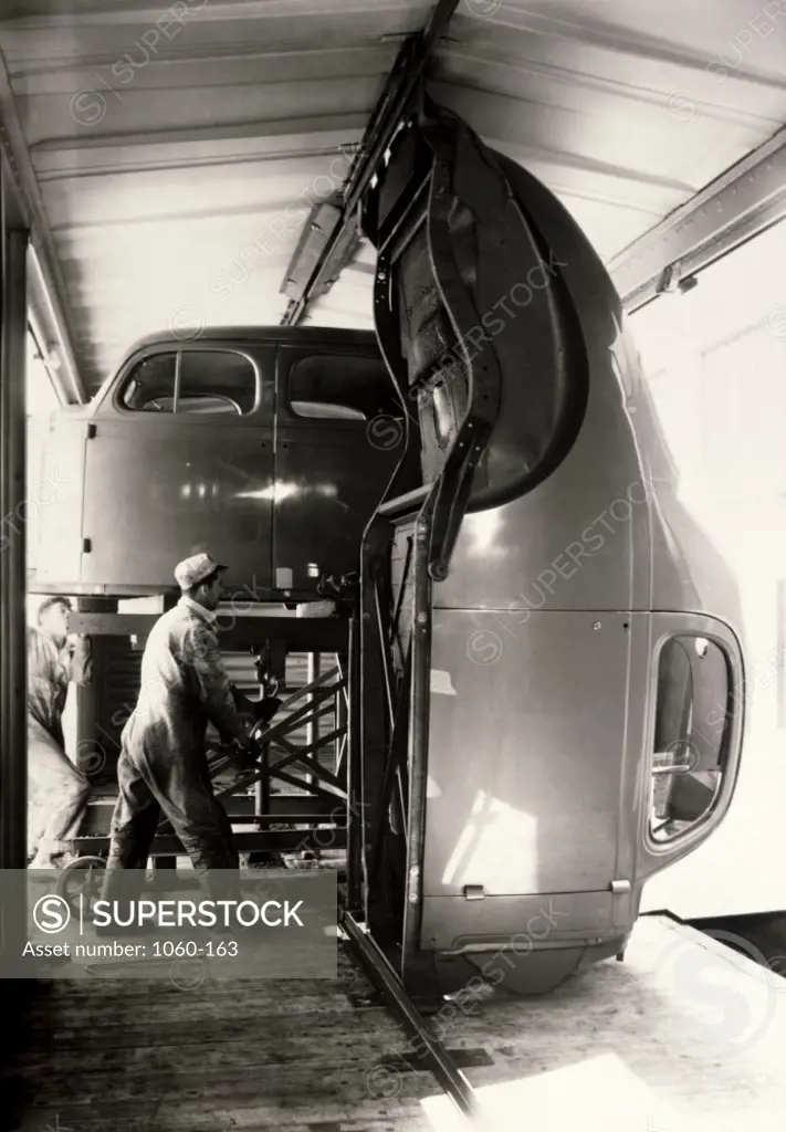 Two male workers working in an assembly plant, Studebaker Assembly Plant, 1936
