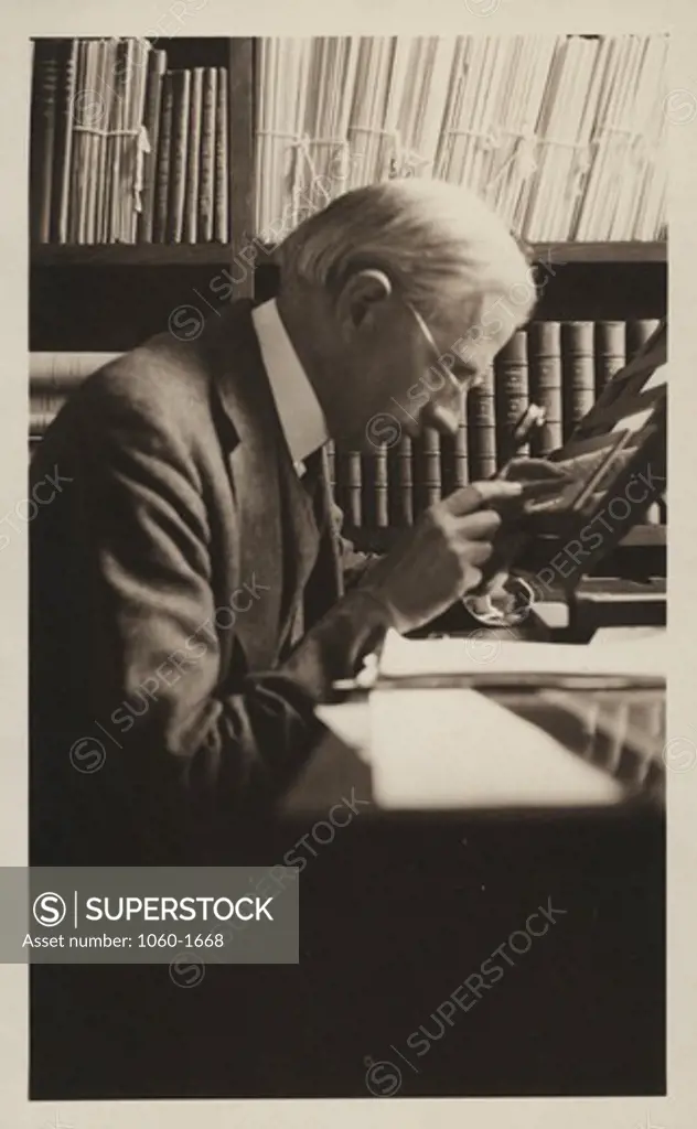 Henry Norris Russell examining a plate in his office at the Main Office Building in Pasadena (same image as #30