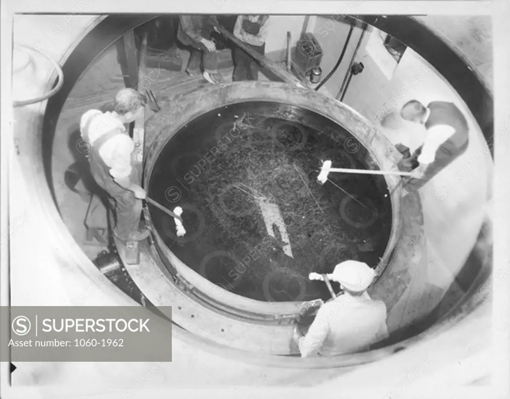 SCRUBBING THE 100-INCH MIRROR WITH CAUSTIC POTASH & WATER SOLUTION USING COTTON SWABS PRIOR TO SILVERING MIRROR.  WALTER S. ADAMS AT UPPER RIGHT