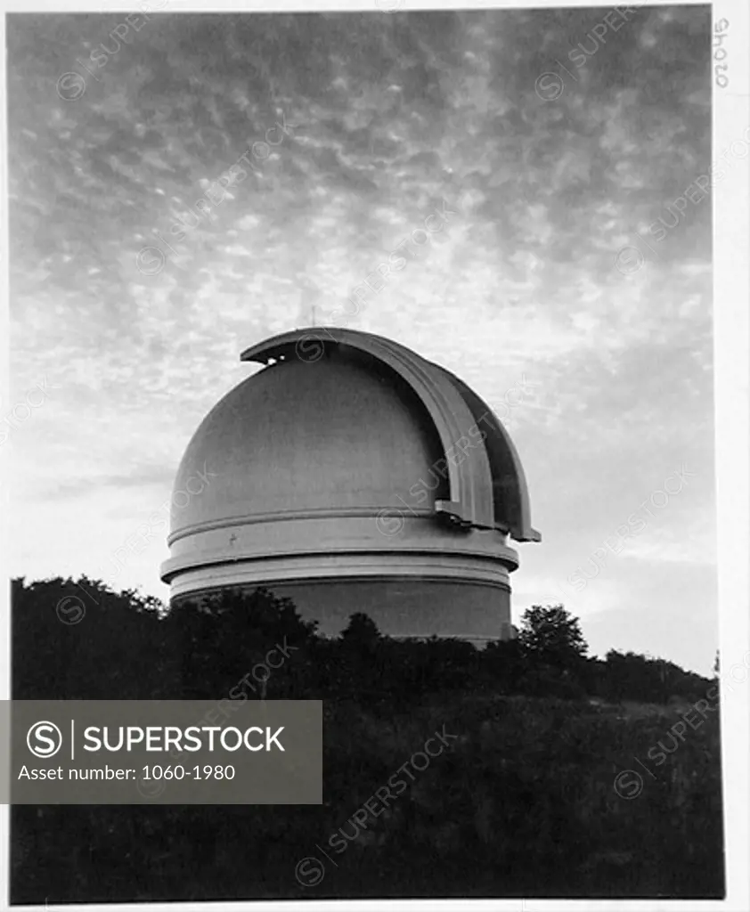 200-INCH TELESCOPE DOME, SHUTTERS OPEN, AT SUNSET, CLOUDS IN THE SKY.