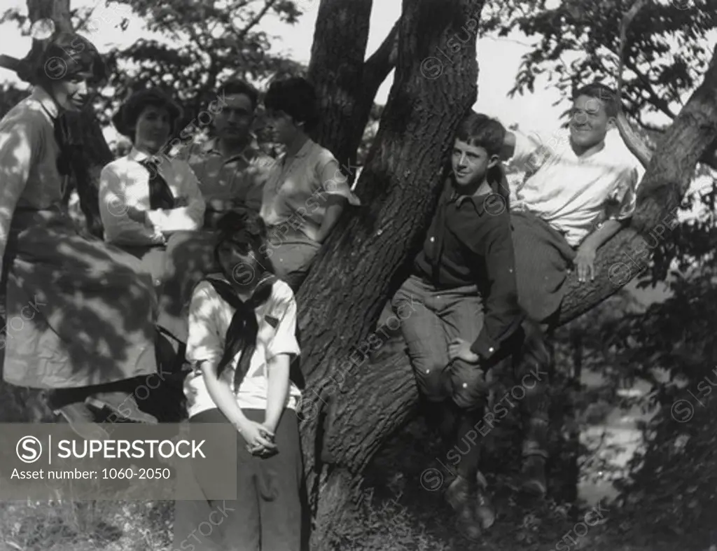 Edwin Powell Hubble (third from left) and unidentified companions (three women, one girl, and two adolescent boys) sitting in tree