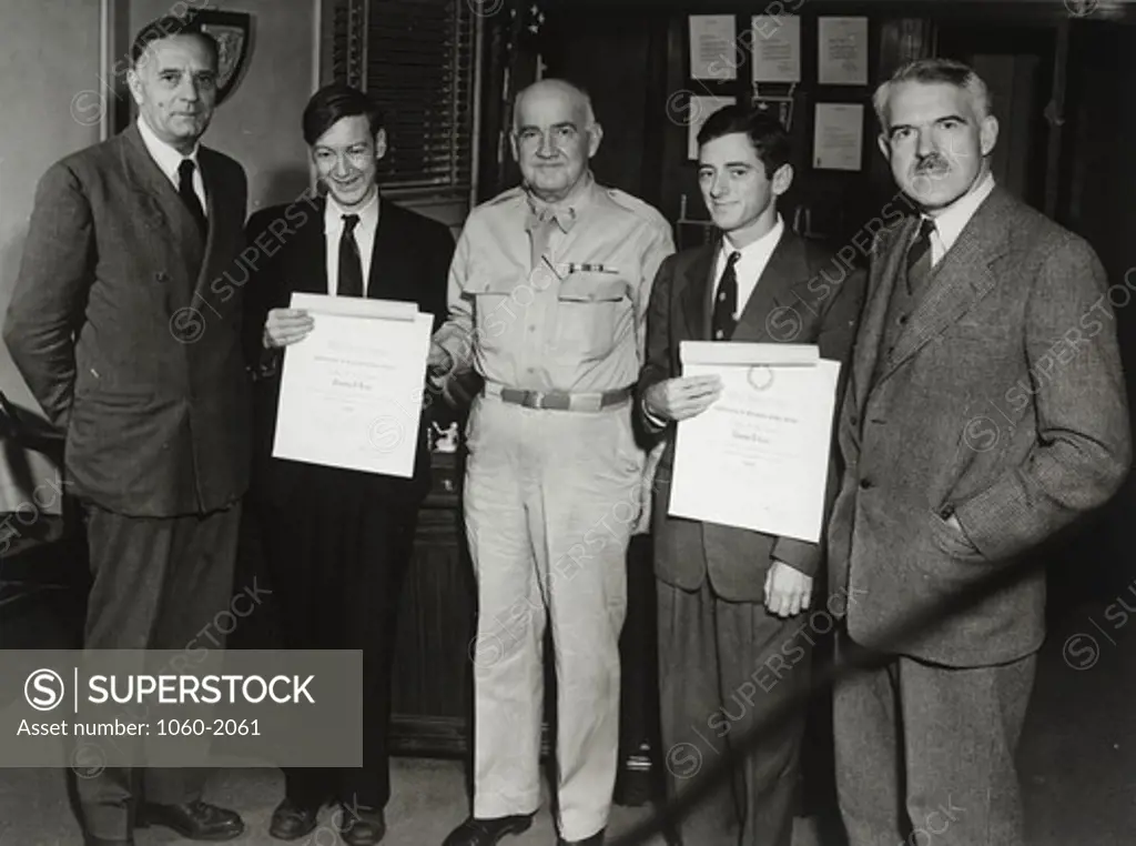 Edwin Powell Hubble, Franklin Reno, Major General Harris, Thomas Carr, and unidentified man. Reno and Carr holding certificates of recognition