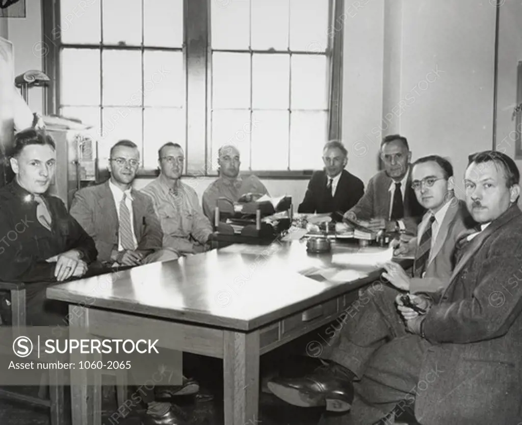 Edwin Powell Hubble (third from right) and number of other men in office of supersonic wind tunnel building