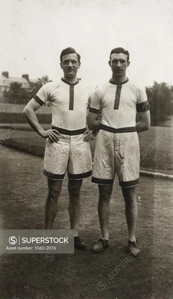 Edwin Powell Hubble and William Ziegler in track team uniforms, standing on track