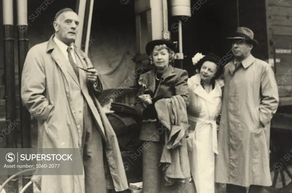 Grace (Burke) Hubble and Edwin Powell Hubble with unknown couple in front of train