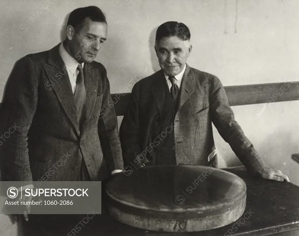 Edward Curtis Franklin and Edwin Powell Hubble, viewing fused quartz mirror for telescopes, at opening of session of American Association for Advancement of Science