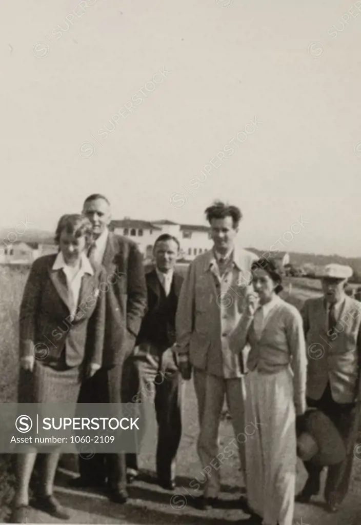 Aldous Leonard Huxley, Maria (Nys) Huxley, Edwin Powell Hubble, Grace (Burke) Hubble, Christopher Isherwood, and John Emerson, standing outside
