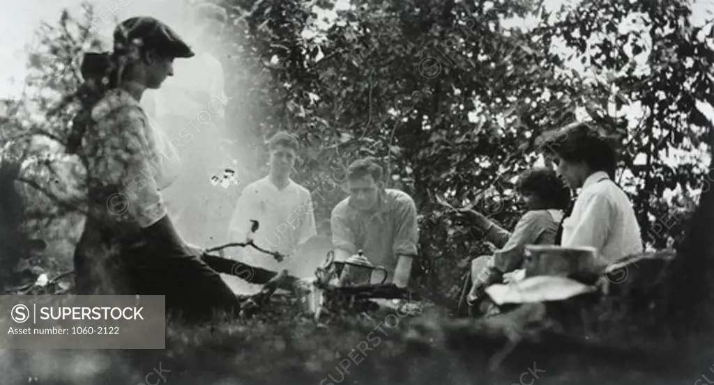 Edwin Powell Hubble (center) and unidentified companions (two women, one girl, and two adolescent boys) sitting around camp fire