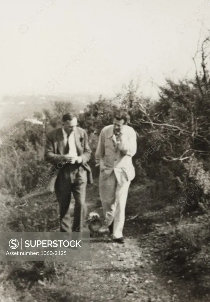 Edwin Powell Hubble and Aldous Huxley walking with Huxley's dog