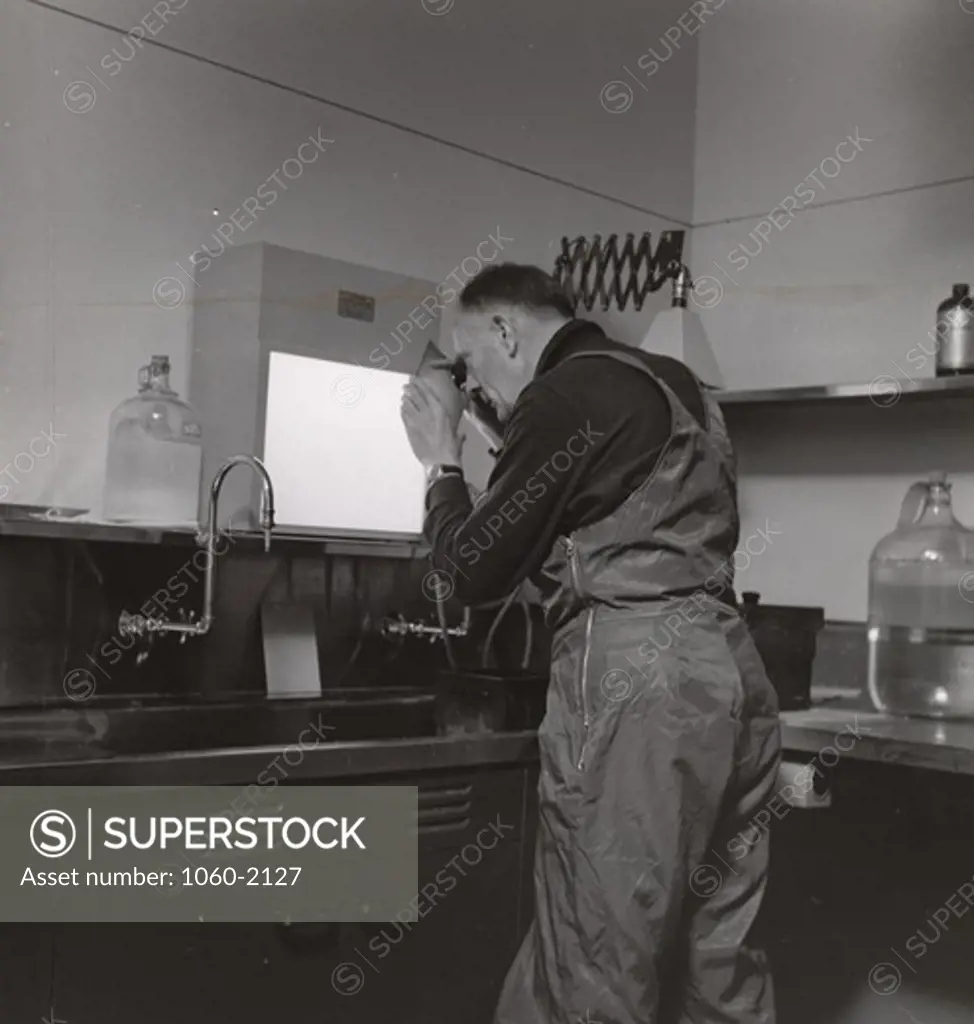 USA, California, San Diego Country, Palomar Observatory, Edwin Powell Hubble examining glass slides in Palomar darkroom