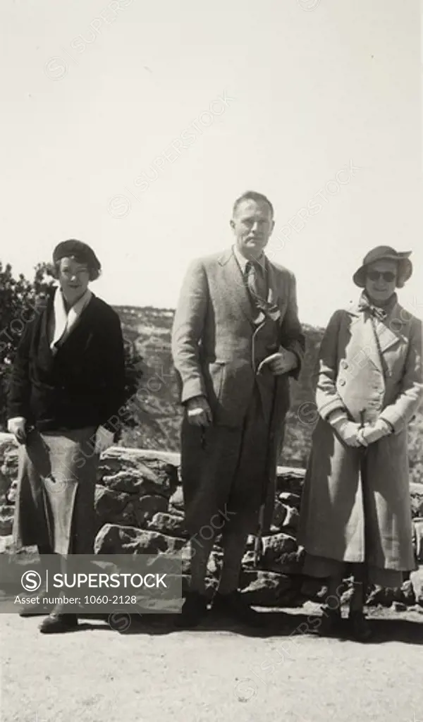 USA, Grand Canyon, Grace (Burke) Hubble, Edwin Powell Hubble, and Betty Baldwin standing at lookout point