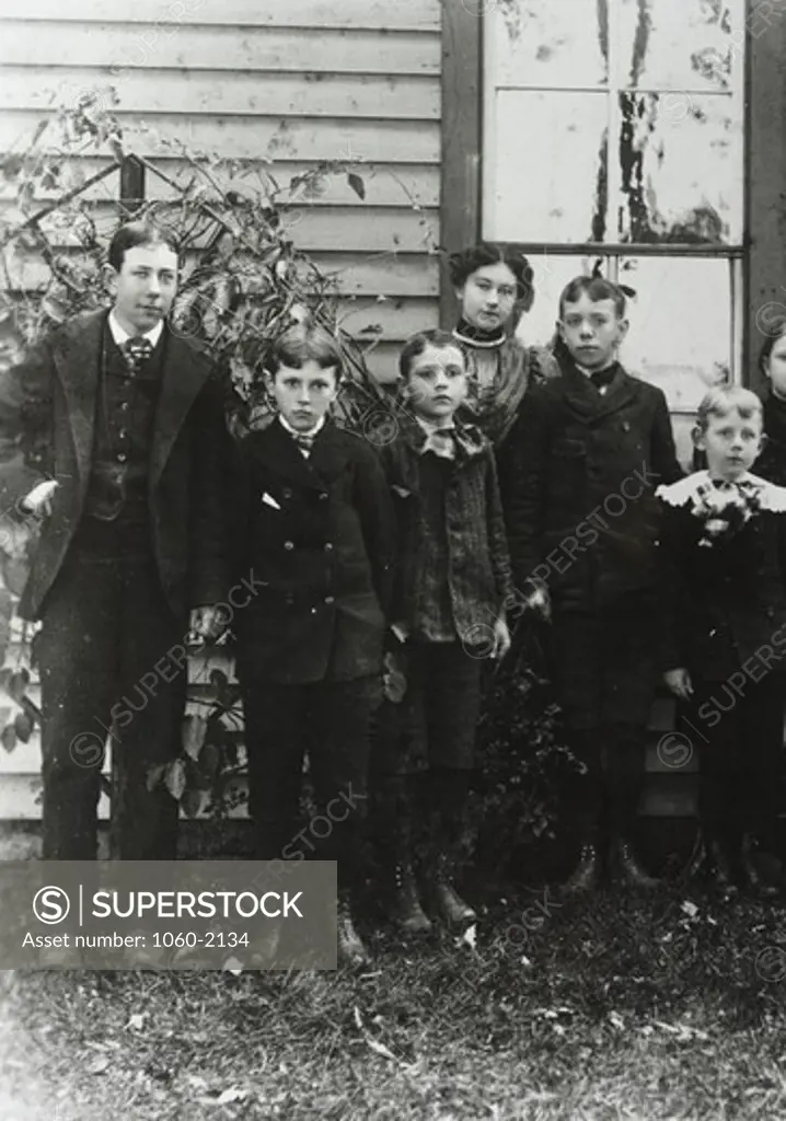 Edwin Powell Hubble, as child, standing outside of building with cousins (third from left)