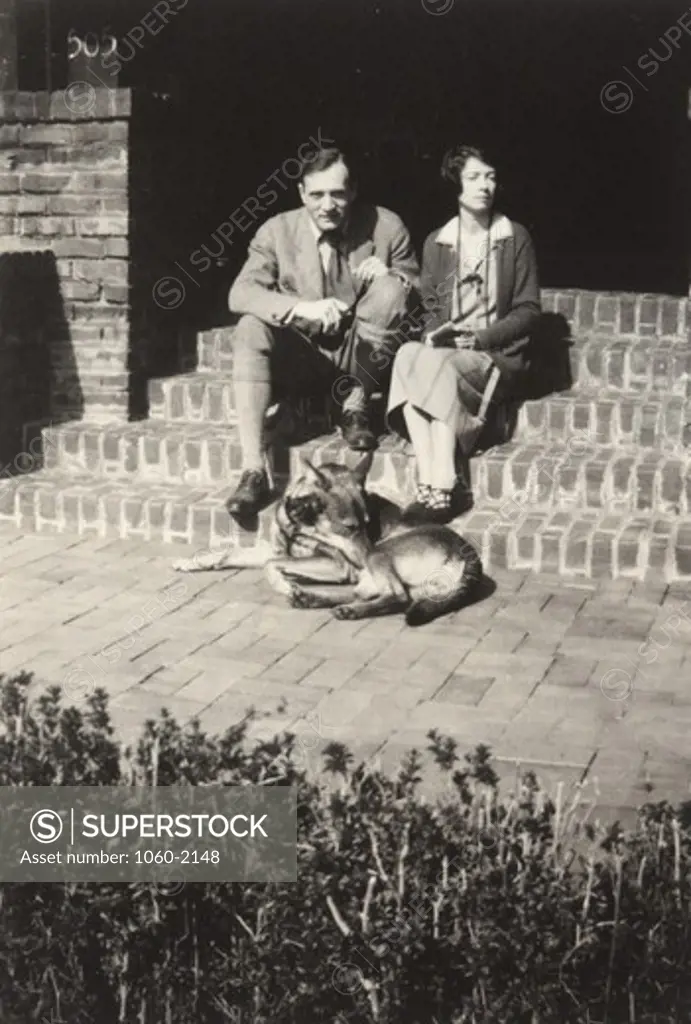 Edwin Powell Hubble and Grace (Burke) Hubble on wedding day, sitting with dog on steps of Burke family home