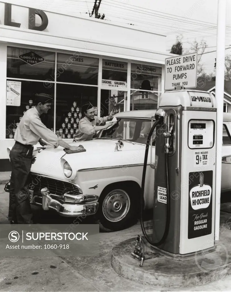 Two gas station attendants cleaning a car, 1957