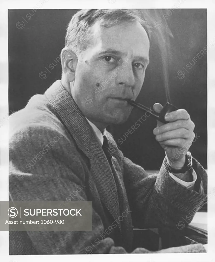 PORTRAIT OF EDWIN HUBBLE SMOKING HIS PIPE AT HIS DESK. -- ALSO HUB 1033(8) --