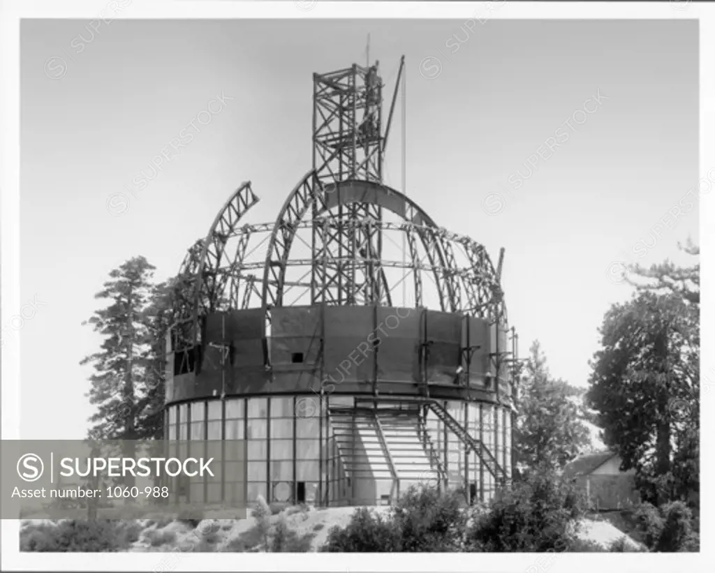 TOP SECTION OF MAIN GIRDER OF HOOKER TELESCOPE DOME BEING HOISTED INTO PLACE.