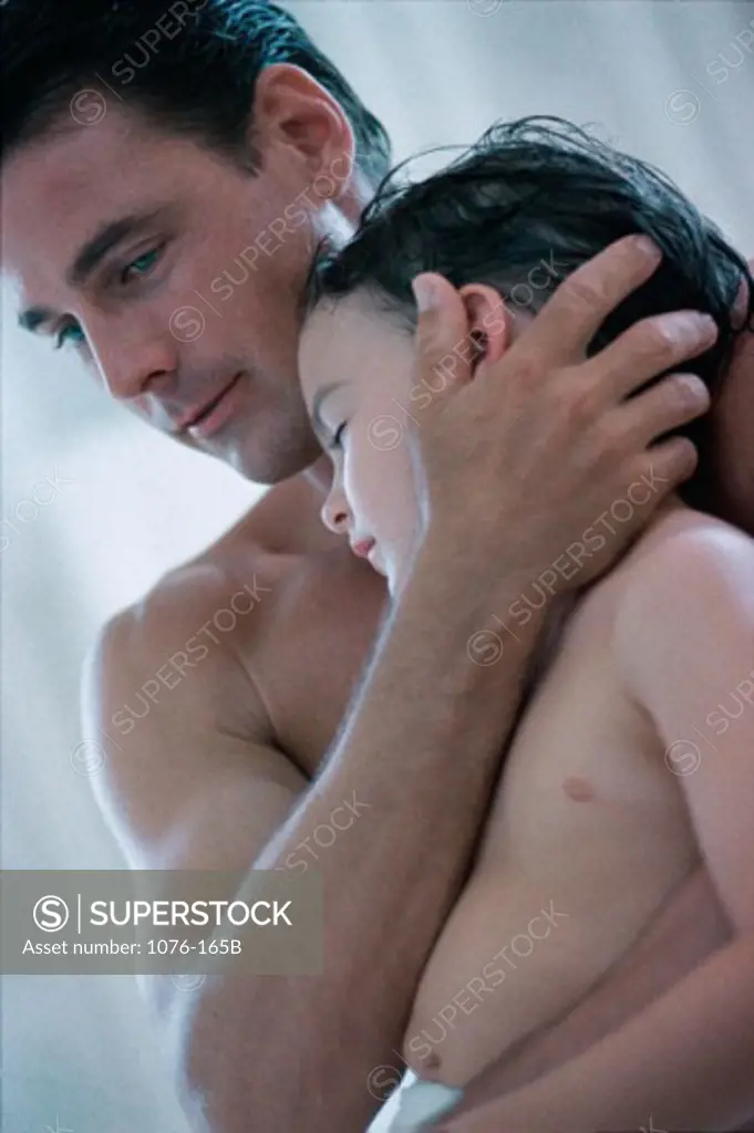 Boy resting on his father's shoulder