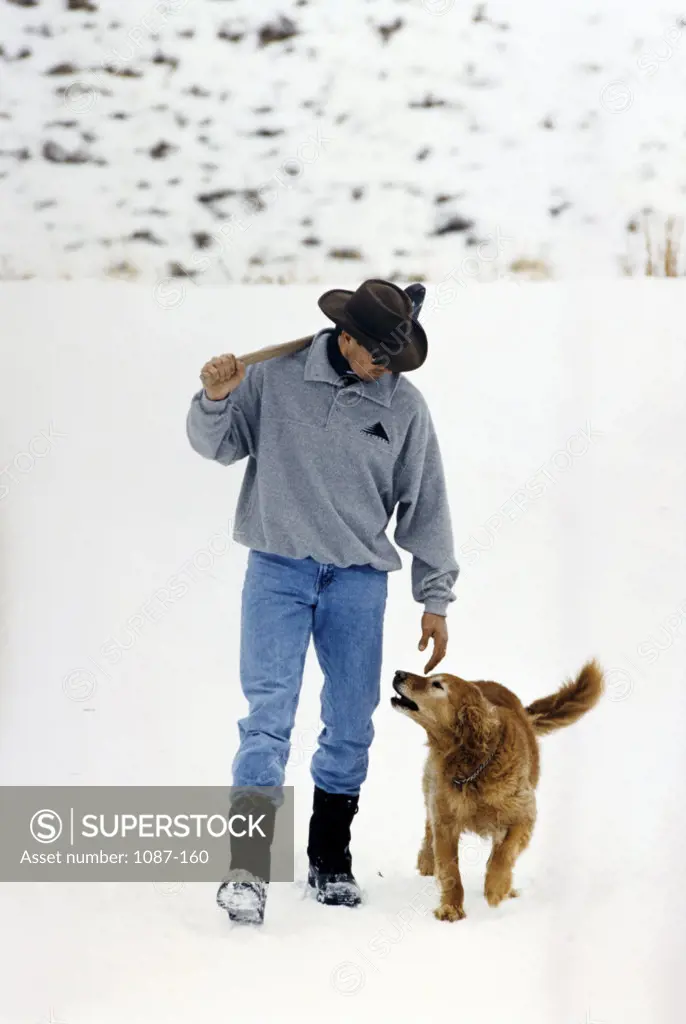 High angle view of a young man walking with his dog